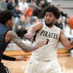 Peninsulas Davien Harris-Williams prepares to pass as Bellevues Tijohn Rodde defends the lane on Wednesday in Port Angeles. (Keith Thorpe/Peninsula Daily News)