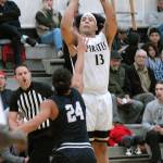 Peninsulas Marquis Gurske, top, attempts a 3-pointer over the head of Bellevues Gabriel Moujaes on Wednesday in Port Angeles. (Keith Thorpe/Peninsula Daily News)