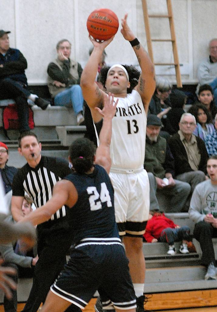 Peninsulas Marquis Gurske, top, attempts a 3-pointer over the head of Bellevues Gabriel Moujaes on Wednesday in Port Angeles. (Keith Thorpe/Peninsula Daily News)