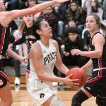 Peninsulas Leillani Padilla, center, is surrounded by the Bellevue defense of, from left, Rokki Brown, Natalie Amos and Makenna Faulkner on Wednesday on the Pirate home court in Port Angeles. (Keith Thorpe/Peninsula Daily News)