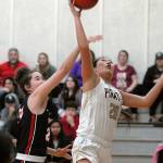 Peninsulas Logan Luke, left, goes for a layup as Bellevues Rutledge defends the lane Wednesday in Port Angeles. (Keith Thorpe/Peninsula Daily News)