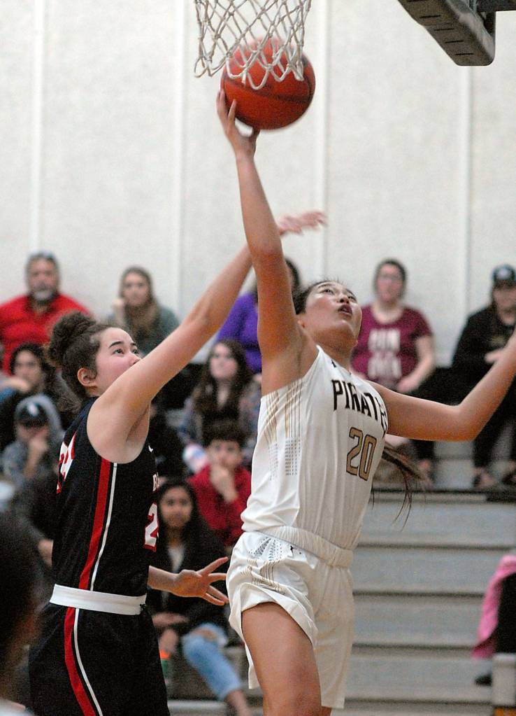 Peninsulas Logan Luke, left, goes for a layup as Bellevues Rutledge defends the lane Wednesday in Port Angeles. (Keith Thorpe/Peninsula Daily News)