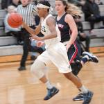 Peninsulas Kayla Johnson drives downcourt pursued by Bellevues MaKenna Faulkner in Port Angeles on Wednesday. (Keith Thorpe/Peninsula Daily News)