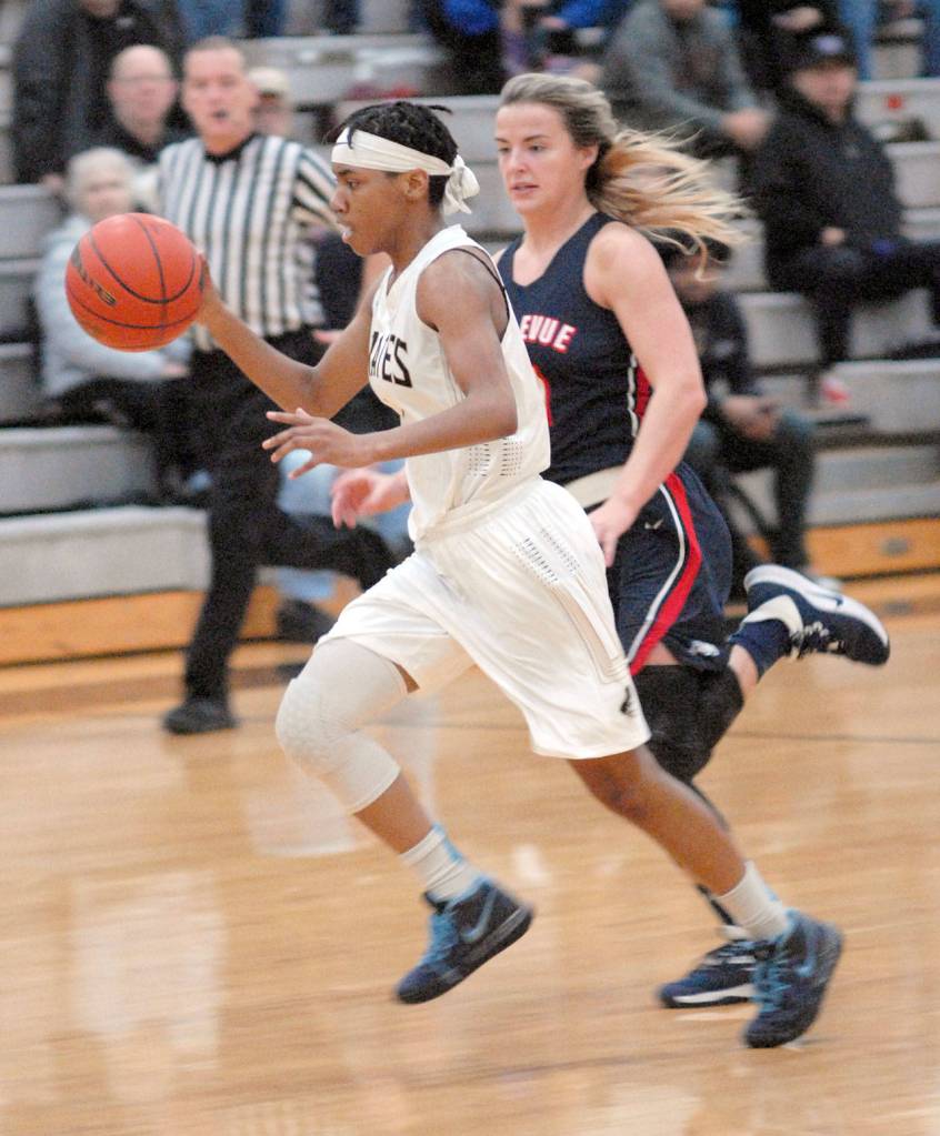 Peninsulas Kayla Johnson drives downcourt pursued by Bellevues MaKenna Faulkner in Port Angeles on Wednesday. (Keith Thorpe/Peninsula Daily News)