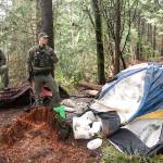 Officers, chain gang remove trash from Morse Creek homeless camp