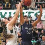 Keith Thorpe/Peninsula Daily News Port Angeles Derek Bowechop, left, and Gary Johnson battle for a rebound with Sequims Hayden Eaton on Thursday night at Port Angeles High School.