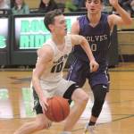 Keith Thorpe/Peninsula Daily News Por Angeles Dru Clark, left, charges past Sequims Dallin Despain at Port Angeles High School on Thursday.