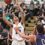 Keith Thorpe/Peninsula Daily News Port Angeles Damen Ringgold, left, retrieves a rebound as Sequims Dallin Despain, right, looks on at Port Angeles High School on Thursday.