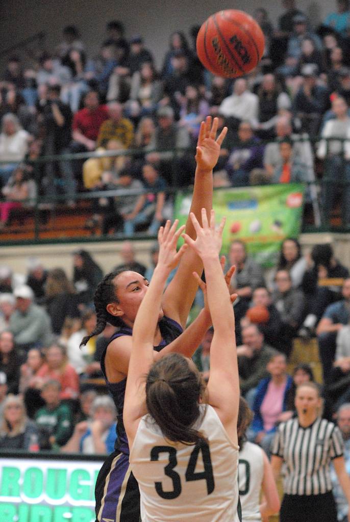 Sequims Jyla Julmist, right, aims for the hoop while defended by Port Angeles Jaida Wood on the Roughrider court Thursday in Port Angeles. (Keith Thorpe/Peninsula Daily News)