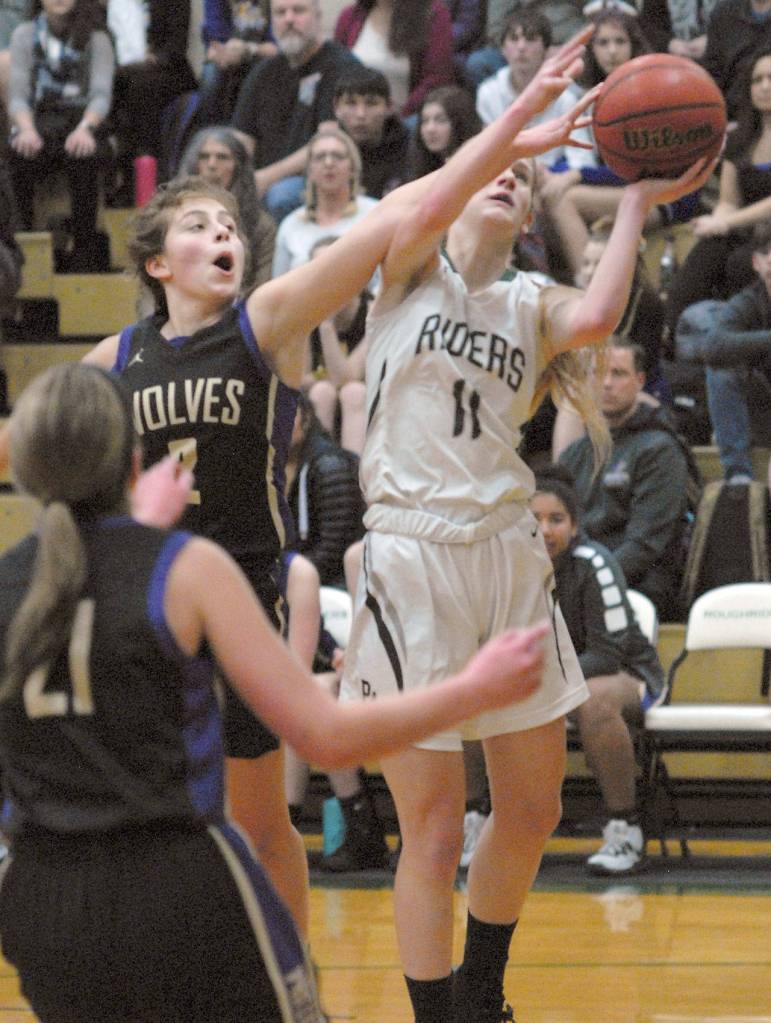 Keith Thorpe/Peninsula Daily News Sequims Jessica Dietzman, top left, tries to deflect a layup by Port Angeles Millie Long as Sequims Kalli Wiker, front, looks on during Thursdays game at Port Angeles High School.