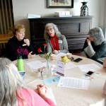 Liz Coker, center, the director of the Jefferson County Homebuilders Association, discusses potential solutions to the housing crisis with others Monday during the monthly luncheon hosted by the Chamber of Jefferson County at the Elks Lodge in Port Townsend. (Brian McLean/Peninsula Daily News)