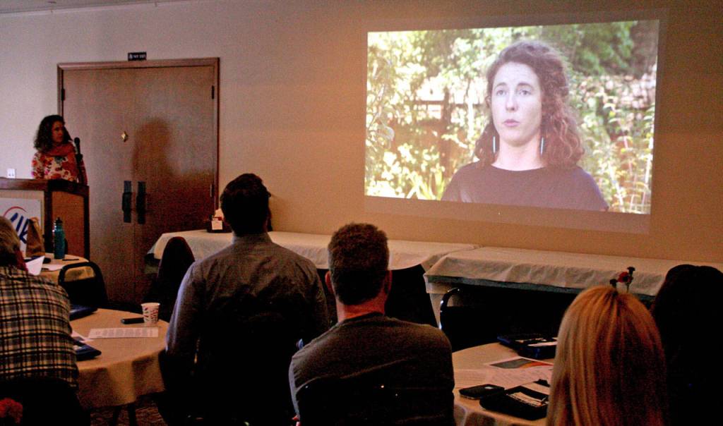 Justine Gonzalez-Berg, the network weaver for the Housing Solutions Network, presents a video Monday during the monthly luncheon provided by the Chamber of Jefferson County at the Elks Lodge in Port Townsend. She appears in the video with others and uses it as a way to facilitate conversations with community groups on the impact of housing. (Brian McLean/Peninsula Daily News)