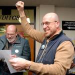 Steve Methner, committee chair for Port Angeles Citizens for Education, right, raises a fist in celebration as fellow committee member Nolan Duce looks over ballot results that showed a capital levy for the Port Angeles School District passing after Tuesdays initial count. (Keith Thorpe/Peninsula Daily News)