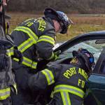 Port Angeles Fire Department paramedics/firefighters work on the best solution to extract a victim during a drill. (Laura A. Foster/Peninsula Daily News)