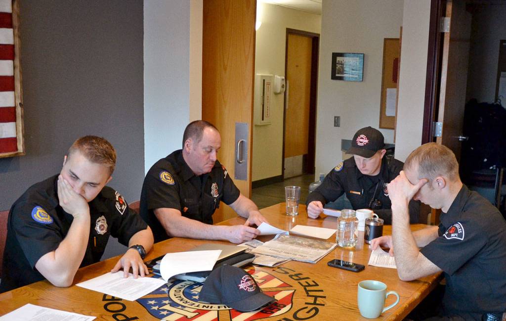 Port Angeles Fire Department B Shift discusses local coronavirus protocols between calls. (Laura Foster/Peninsula Daily News)