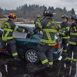 Port Angeles Fire Department B Shift practices safely rescuing a victim from being entrapped in a car. (Laura Foster/Peninsula Daily News)