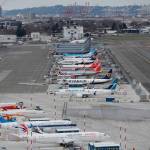 This Feb. 23, 2018, file photo shows cranes from the Port of Seattle in the background and airplanes parked at a Boeing facility at Boeing Field in Seattle. The U.S. Department of Justice filed a federal lawsuit Monday, Feb. 10, 2020, against King County seeking to overturn the countys ban on all immigration deportation flights at the airport. (Ted S. Warren/The Associated Press file)