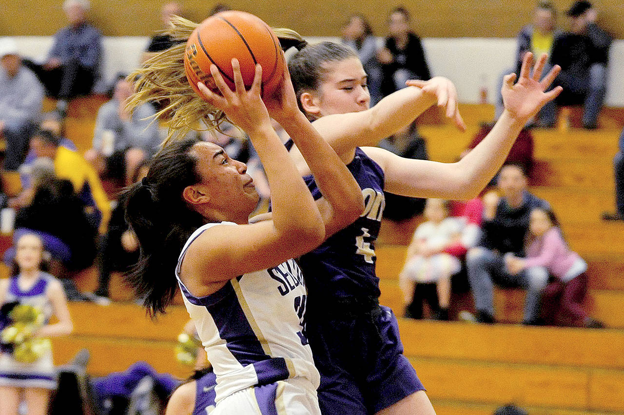 Conor Dowley/Olympic Peninsula News Group Sequims Jayla Julmist (left) prepares to shoot while defended by North Kitsaps Sophia Baugh earlier this season