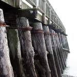 Pilings stacked at an angle hold a walkway atop the south breakwater at Point Hudson, although the walkway has been closed. The preferred alternative would be to replace the structure with steel pilings in a smaller footprint than what currently exists. (Brian McLean/Peninsula Daily News)