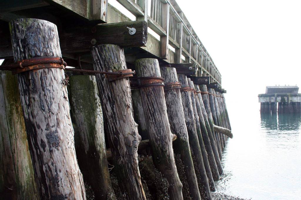 Pilings stacked at an angle hold a walkway atop the south breakwater at Point Hudson, although the walkway has been closed. The preferred alternative would be to replace the structure with steel pilings in a smaller footprint than what currently exists. (Brian McLean/Peninsula Daily News)