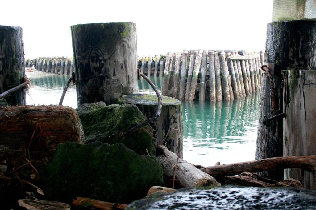 The north breakwater at Point Hudson is seen through a hole in the south breakwater, which an engineering firm suggested should be completely replaced at a cost between $5.5 million and $6.5 million. (Brian McLean/Peninsula Daily News)