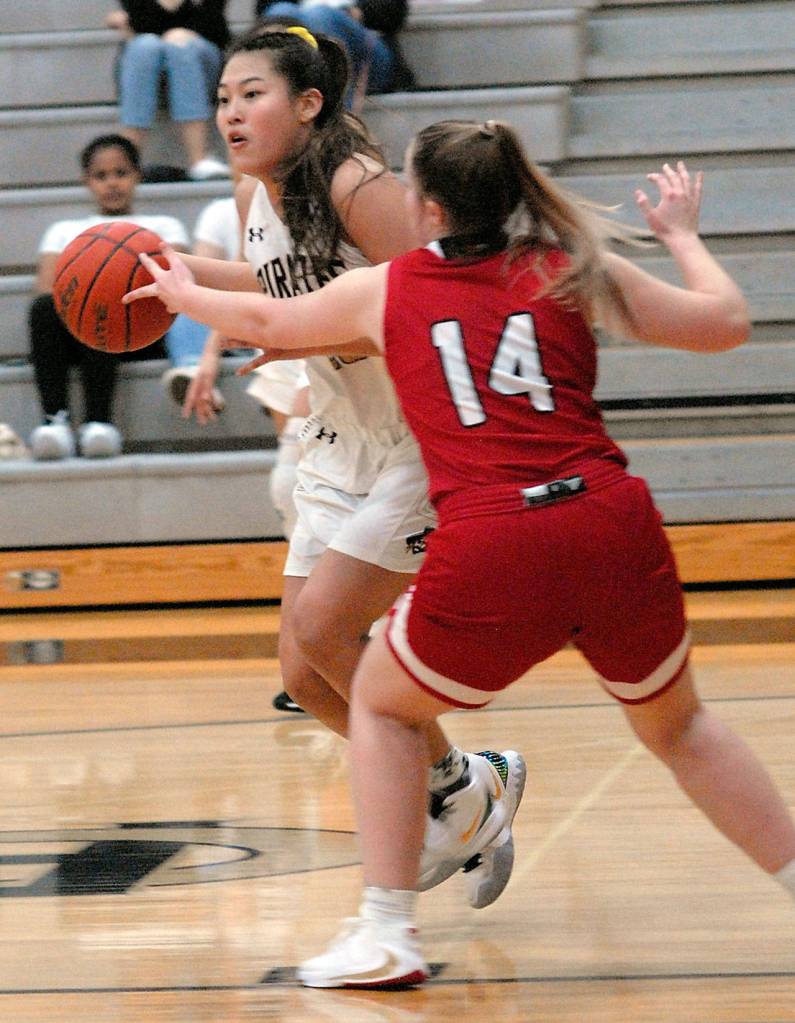 Keith Thorpe/Peninsula Daily News Peninsulas Logan Luke, left, slips past the defense of Skagit Valleys Brooklyn Johnson on Wednesday in Port Angeles.