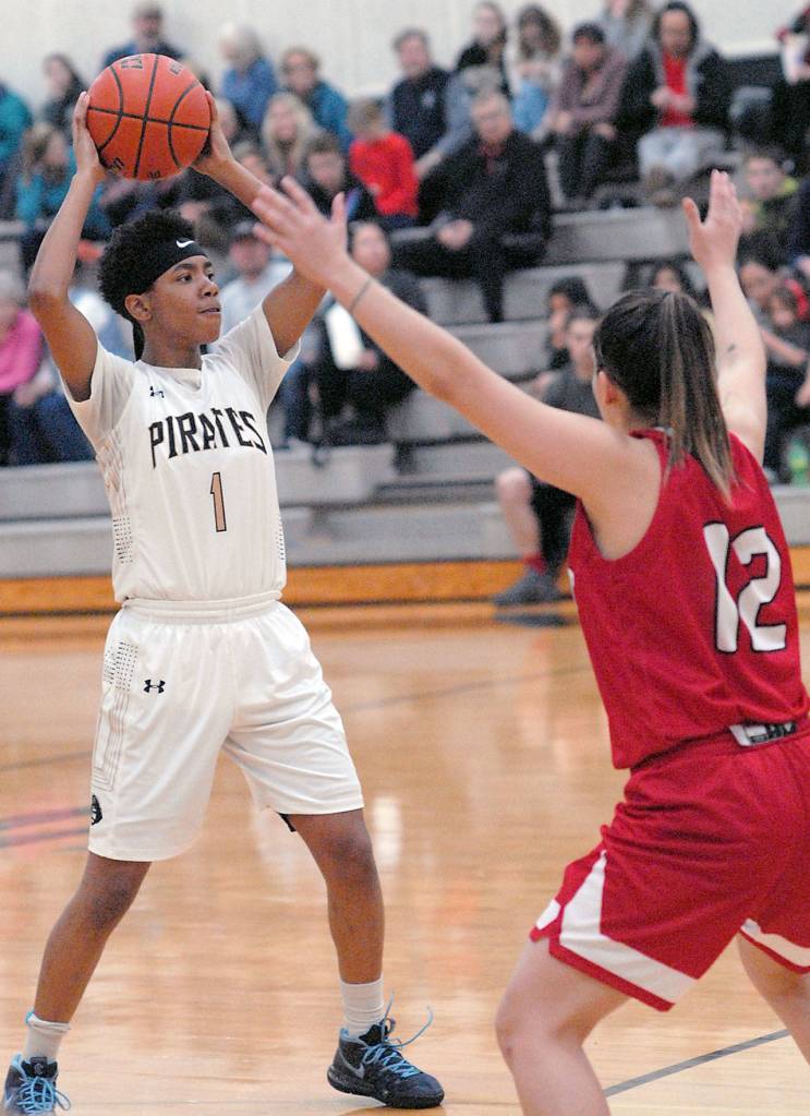 Keith Thorpe/Peninsula Daily News Peninsulas Kayla Johnson, left, fends of the defense of Skagit Valleys Annaleis Reyes-Guzman on Wednesday night at Peninsula College in Port Angeles.