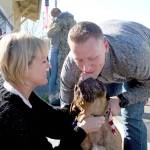 Kate Krusely, left, and Cash greet U.S. Navy Lt. Julian Krusely on Tuesday outside of the Chamber of Jefferson County in Port Townsend. The Kruselys recently moved to Gig Harbor, although Julian departed on the USS Nimitz after he had been in his new house for just five days. (Brian McLean/Peninsula Daily News)