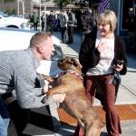 U.S. Navy Lt. Julian Krusely, left, is welcomed by his dog, Cash, and his wife, Kate, as he steps off a bus Tuesday. Sailors from the USS Nimitz will be in Port Townsend through Thursday, and they will be on buses traveling from Naval Magazine Indian Island. (Brian McLean/Peninsula Daily News)