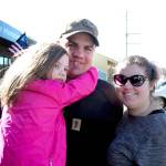 U.S. Navy sailor Dennis VanLeeuwen, center, is greeted by his wife, Brittany, and daughter, Harper, on Tuesday outside of the Chamber of Jefferson County in Port Townsend. (Brian McLean/Peninsula Daily News)