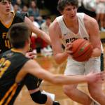 Keith Thorpe/Peninsula Daily News Port Angeles John Vaara, right, looks out from the key as Fifes Ivan Gonzalez-Cortez, left, and Kevin Williams defend the lane on Thursday night in Port Angeles.