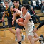 Keith Thorpe/Peninsula Daily News Gary Johnson of Port Angeles charges past Fifes Ivan Gonzalez-Cortez, center, and Kevin Williams, left, during the first quarter on Thursday in Port Angeles.
