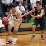 Keith Thorpe/Peninsula Daily News Port Angeles Stuart Methner, left, slip around Fifes Kevin Williams during Thursday nights playoff game in Port Angeles.