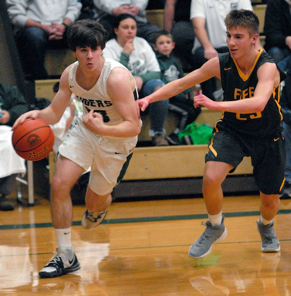 Keith Thorpe/Peninsula Daily News Port Angeles Stuart Methner, left, slip around Fifes Kevin Williams during Thursday nights playoff game in Port Angeles.