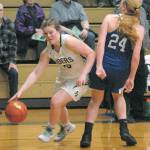 Keith Thorpe/Peninsula Daily News Port Angeles Myra Walker slides around Eatonvilles Kya Stewart in a push to the lane on Friday night in Port Angeles.