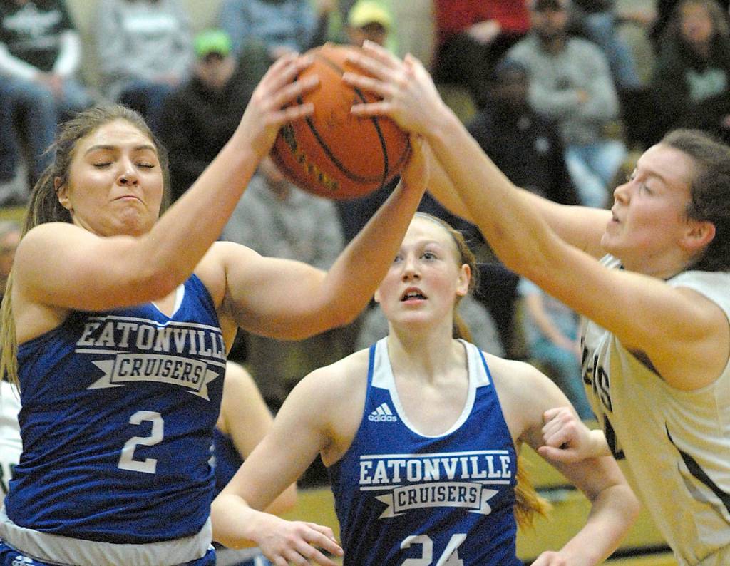 Keith Thorpe/Peninsula Daily News Eatonvilles/Brooklynn Lucht, left, and Port Angeles Jaida Wood, right, fight for a rebound as Eatonvilles Kya Stewart looks on during the second quarter of Friday nights game in Port Angeles.