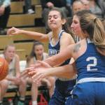 Keith Thorpe/Peninsula Daily News Port Angeles Ava Brenkman, center, vies for a loose ball with Eatonvilles Emily Bennett, left, and Brooklynn Lucht at Port Angeles High School on Friday night.
