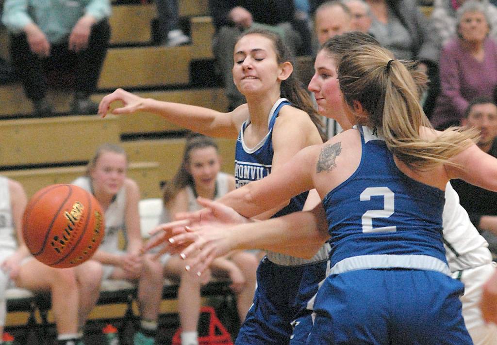 Keith Thorpe/Peninsula Daily News Port Angeles Ava Brenkman, center, vies for a loose ball with Eatonvilles Emily Bennett, left, and Brooklynn Lucht at Port Angeles High School on Friday night.