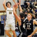 <strong>Lonnie Archibald</strong>/for Peninsula Daily News                                Spartan Carter Windle (10) puts up a shot against Seton Catholics Griffin Young and Andrew Olson (33) Friday in Forks where the Cougars defeated Forks 66-48 in the 1A Southwest District Tournament.