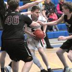 Keith Thorpe/Peninsula Daily News Neah Bays Darrin Horejsi, center, is surrounded by Lopez Island defenders, including Reese Hamilton, left, and Ellery Jones, right, on Saturday in Joyce.
