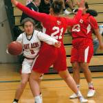 Neah Bays Shilaily Woodruff, left, bulls her way around the defense of Tulalip Heritages Jacynta Myles-Gilford as her teammate, Krislyn Parks looks on during Tuesday nights game at Port Angeles High School. (Keith Thorpe/Peninsula Daily News)
