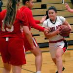 Neah Bays Ruth Moss, right, drives to the lane as Tulalip Heritages Claudia Parker, left, and Jacynta Mules-Gilford defend on Tuesday at Port Angeles High School. (Keith Thorpe/Peninsula Daily News)