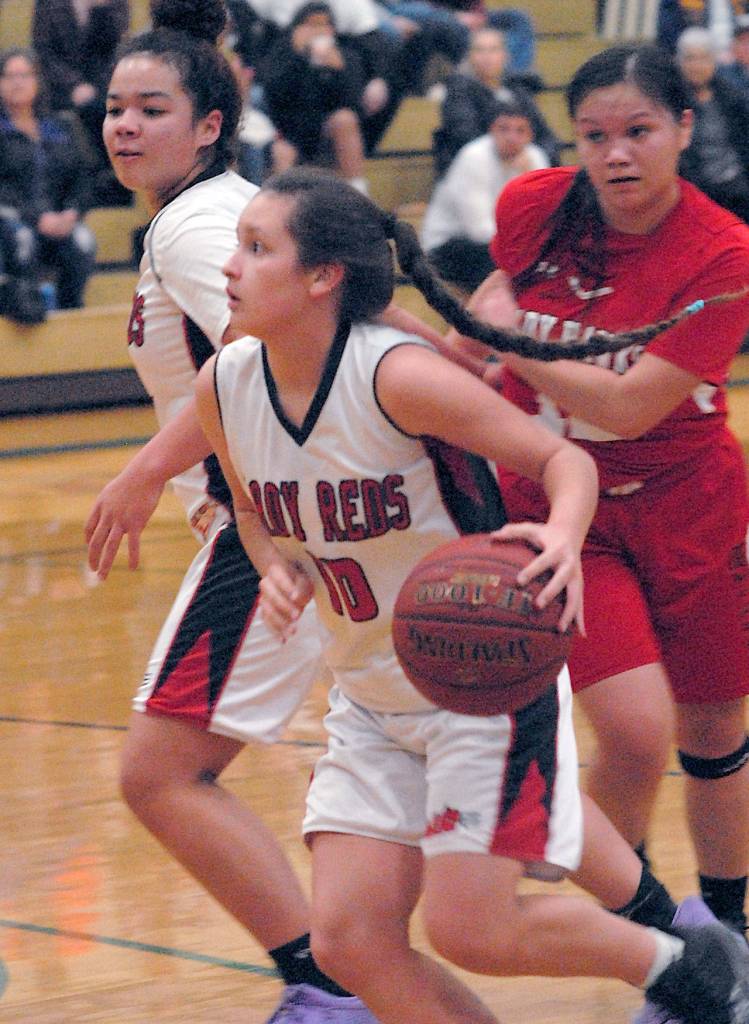 Neah Bays Allie Green, front, evades the defense of Tulalip Heritages Deachae Jones, right, as Greens teammate, Oceana Aguirre, left, clears the way on Tuesday in Port Angeles. (Keith Thorpe/Peninsula Daily News)