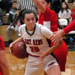 Neah Bays Cei J Gagnon, left, works her way past Tulalip Heritages Deachae Jones tries to hold her off on Tuesday night in Port Angeles. (Keith Thorpe/Peninsula Daily News)