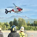 An Airlift Northwest helicopter lands in front of a group of Clallam firefighters recently. Airlift Northwest will no longer be reciprocating care for other air medical company memberships, such as Life Flight Network, starting March 25. (Jay Cline)