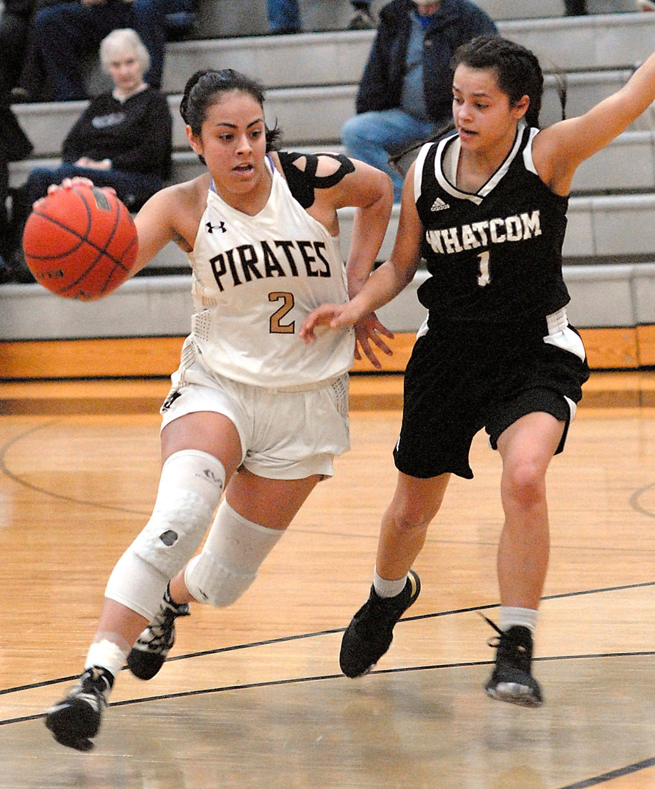 Peninsulas Lellani Padilla, left, pushes past Whatcoms Carmelita Rodriguez during Wednesdays game in Port Angeles. (Keith Thorpe/Peninsula Daily News)