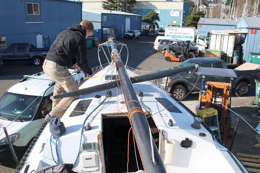 Team FAST Skipper Odin Smith removes the chain plate that is going to be replaced on the teams 27-feet-long sloop. (Zach Jablonski/Peninsula Daily News)