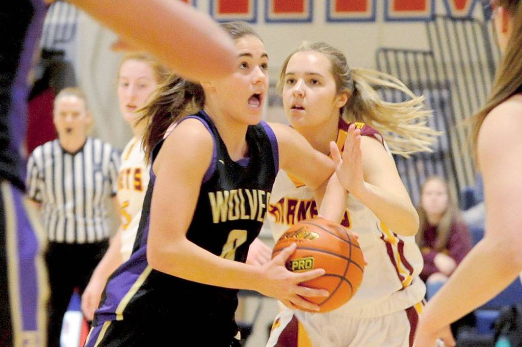 Sequim Wolves forward Hope Glasser drives through traffic to attempt a layup in the third quarter of the Wolves 57-53 loss to the White River Hornets on Feb. 20. Glasser scored seven of the Wolves first 10 points and 11 overall, but the Wolves came up short in the final few minutes against the Hornets in a district playoff loser-out game on Feb. 20 to qualify for the regional round of the 2A State Championships. (Conor Dowley/Olympic Peninsula News Group)