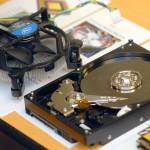 A computer fan and a hard drive sit exposed after being pulled from a decommissioned computer. (Keith Thorpe/Peninsula Daily News)