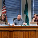 Jefferson County commissioners Kate Dean, left, David Sullivan and Greg Brotherton discuss the changes to two ordinances on shooting ranges and limiting future ranges to indoors only during their meeting Monday. (Zach Jablonski/Peninsula Daily News)